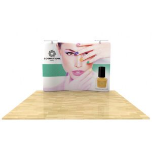 A display poster features a model with vibrantly colored nails placed near her face, showcasing various nail polish shades. The brand name "Cosmetique Paris" and a nail polish bottle are prominently displayed on the bottom right of the poster. The setup is placed on a wooden floor.